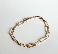 Riley medium chain bracelet is a great choice for those that want the trendy paper clip chain with a slightly lighter look and feel. NOTE: Gold-filled jewelry has a much higher amount of gold in it than gold-plated, making it more valuable (almost 100% more gold than gold-plated jewelry), more durable (won't chip or tarnish), safe for those with metal allergies and longer-lasting (10-30 years). Gold Paperclip Box Chain Bracelet, Gold Minimalist Paperclip Bracelet With Box Chain, Minimalist Gold Paperclip Bracelet With Box Chain, Yellow Gold Chunky Chain Paperclip Bracelet, Yellow Gold Paperclip Bracelet With Chunky Chain For Gift, Chunky Yellow Gold Paperclip Bracelet, Yellow Gold Paperclip Bracelet With Chunky Chain, 14k Gold Chunky Chain Bracelet With Rectangular Links, Everyday Yellow Gold Chunky Paperclip Bracelet