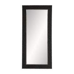 a black framed mirror sitting on top of a white wall