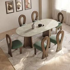 a dining room table with six chairs and a rug on the floor in front of it