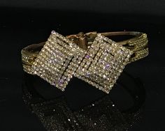 Stunning vintage crystal statement bangle in fantastic condition. This hinged gold  tone bracelet should fit most wrist sizes. Rows of sparkling prong set crystals in 3 d rectangular pattern. Is much nicer than photos! Gift wrapped and ready to wear Glamorous Evening Crystal Bangle Bracelet, Formal Sparkling Bangle, Glamorous Gold Bangle For Parties, Formal Cuff Bracelet With Sparkling Stones, Formal Bangle Cuff Bracelet With Sparkling Stones, Gold Crystal Bangle For Formal Occasions, Formal Gold Crystal Bangle, Sparkling Dazzling Bangle For Formal Occasions, Dazzling Sparkling Bangle For Formal Occasions