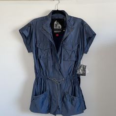 Nwt G.E.T Windbreaker Short Sleeve Blue Jacket -Size S -Zip-Up, As Well As Button Up -4 Front Pockets (2 On The Chest, 2 By The Waist) - Adjustable Waist Strings -Zipper On The Back Of Collar -Condition Is New With Tags Blue Utility Top For Spring, Blue Casual Utility Jacket For Outdoor, Blue Utility Tops For Spring, Casual Navy Utility Jacket For Spring, Zip Up Jacket, 2 On, Blue Jacket, Zip Ups, Button Up