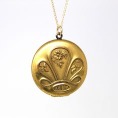 Stunning antique gold filled crown-like motif Art Nouveau locket with floral accents! The backside of this early 1900s locket is engraved with initials that look like they could be EPV. The inside of locket has original photos, bezels, and lucite covers. The locket is modeled on a 20 inch gold filled chain. ERA - Circa 1900s - Art Nouveau  METAL / MATERIAL - Gold filled locket, 14k gold filled chain, photographs   MARKINGS / HISTORY - Chain is marked "14/20 GF"  CONDITION - Good antique condition. Gold filled metal has been professionally polished & cleaned. Age appropriate patina & wear remains. Photos are well preserved. SIZE / MEASUREMENTS - Chain Modeled: 20 inches, Pendant (including bail): 1 1/2 x 1 1/4 inches, Weight (without chain): 11.6 grams PRESENTATION - Listing includes a comp Gold Oval Jewelry With Historical Design, Antique Yellow Gold Necklace With Historical Design, Collectible Yellow Gold Necklace With Antique Finish, Vintage Yellow Gold Jewelry With Historical Design, Victorian Gold Jewelry With Historical Design, Antique Medallion Jewelry With Historical Design, Ceremonial Medallion Jewelry With Historical Design, Victorian Filigree Locket Necklace In Yellow Gold, Victorian Filigree Yellow Gold Locket Necklace