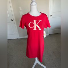 Nwt Calvin Klein Tshirt Logo Dress In Pink Size Medium. The Logo Has A Bit Of Sparkles In It. Cotton Spandex Blend, Loose Fit And Comfortable. Casual Red Calvin Klein Tops, Fitted Short Sleeve Calvin Klein T-shirt, Calvin Klein Crew Neck Tops For Loungewear, Graphic Print Stretch Crew Neck Dress, Crew Neck Graphic Print Stretch Dress, Stretch Graphic Print Crew Neck Dress, Stretch Graphic Print Dress With Crew Neck, Fitted Calvin Klein Short Sleeve T-shirt, Short Sleeve T-shirt Dress For Loungewear