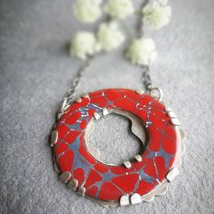 Enamel and silver pendant, contemporary jewel in red and gray, enameled circular pendant for women, handmade necklace, enameled jewelry. Original enamel and silver pendant with a circular shape, in original red and gray autumnal tones, made with liquid enamels vitrified in an enameling oven at temperatures of about 830 degrees Celsius and using sgraffito techniques to make the cracks that characterize this collection. The liquid enamel is applied in light layers, with a brush, dried and subseque Red Enamel Round Necklace, Red Enamel Round Pendant Necklace, Handmade Red Enamel Necklace, Handmade Red Enamel Necklaces, Red Handmade Enamel Necklaces, Handmade Red Enamel Jewelry, Red Enamel Jewelry With Large Pendant, Unique Red Enamel Necklaces, Red Circular Jewelry For Gifts