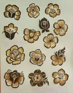 a bunch of flowers that are on a white board with some brown and gold designs