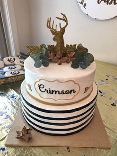 a cake decorated with leaves and a deer on top