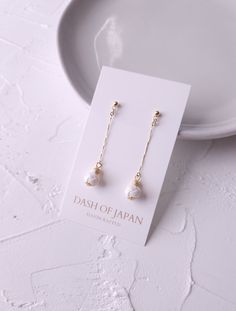 "Introducing our long-length earrings made with Japanese Mizuhiki paper cord. Each knots are meticulously crafted with ultra-fine Mizuhiki cords and  adorned with sparkling petite metal beads and a delicate, shimmering dainty chain.  Despite their slightly longer length, these earrings maintain a petite and subtle profile, allowing for a gentle sway that effortlessly complements your everyday look.  Crafted from Mizuhiki, they are exceptionally lightweight, ensuring comfort without any strain. ➣ Minimalist White Linear Earrings For Pierced Ears, Minimalist White Linear Long Drop Earrings, White Dangle Threader Earrings, White Minimalist Dangle Threader Earrings, Everyday White Pearl Drop Threader Earrings, Minimalist White Threader Earrings For Everyday, White Minimalist Long Drop Earrings, Elegant White Long Drop Threader Earrings, Dainty White Linear Single Earring