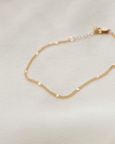 The bracelet that shines like summer incarnate. Each chain is dotted with little sunbursts to catch the light—like fireflies, twinkling lights and golden hour all rolled into one! Style it solo, stack with your favorite bracelets or add a charm for an extra sparkle of personalization. Want to shine even brighter? Check out the full Radiant Collection. Dainty Yellow Gold Beaded Bracelets In 14k Gold Filled, Adjustable 14k Gold Filled Bracelets With Satellite Chain, Delicate Yellow Gold Beaded Bracelets For Everyday, Dainty Satellite Chain Bracelet For Everyday, Delicate Gold Jubilee Bracelet For Everyday Wear, Delicate Adjustable Jubilee Chain Bracelet, Delicate Jubilee Gold Bracelet For Everyday Wear, Delicate Jubilee Gold Bracelet For Everyday, Adjustable Minimalist Gold Bracelet With Satellite Chain