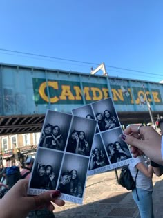 two people holding up some old photos in front of an overpass with the words camden and love on it