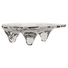 a glass table that is shaped like an upside down triangle