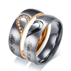 two wedding rings with diamond accents on each side and the word love is in the middle