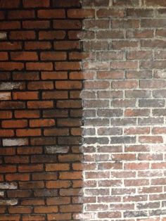 a red fire hydrant sitting next to a brick wall