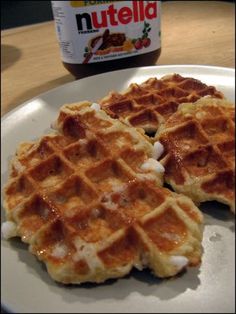 three waffles sitting on top of a white plate