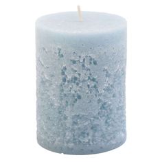 a white candle that has some water on the top and is in front of a white background