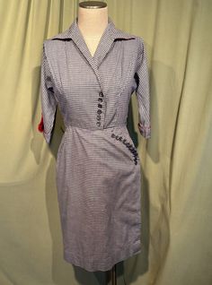 This is a wonderful vintage dress from the 40s. Labeled R & K Originals, Personally Yours. No size tags. The bust measures 36", waist 28", hip 36", see measurements below.   Made of a blue & white gingham check cotton with red lining.  It has 3/4 length sleeves with flared cuffs with button accents & red lining. The sleeves are not "Set-on" sleeves, but part of the front & back panels. No pockets. Below knee length. Collared V neckline. The collar is lined in red too & has straight points. It has string belt loops, but no belt (a red belt would be divine!). Fit and flare shape with a stitched waist & softly flared skirt. The entire skirt is lined in red cotton. The bodice has a single pleat on each side running from the shoulder seam to the center bust on the diagonal. Buttons down the fro Fitted Retro Plaid Vintage Dress, Fitted Plaid Retro Vintage Dress, Retro Plaid Fitted Vintage Dress, Retro Fitted Knee-length Plaid Dress, Fitted Retro Knee-length Plaid Dress, Fitted Knee-length Retro Plaid Dress, Fitted Gingham Retro Vintage Dress, Retro Fitted Gingham Vintage Dress, Fitted Vintage Gingham Dress In Retro Style