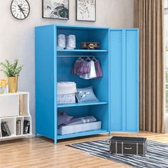 a blue cabinet in a room with pictures on the wall and a rug underneath it