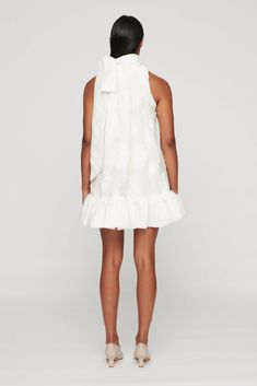 The Atticus Mini Dress features a high neckline with a bow detail that pairs perfectly with the short ruffled hem. The jacquard fabric elevates and provides depth to this mini dress! The Atticus is perfect for brides, as it is a charming silhouette with feminine details. 67% polyester, 26% cotton, 7% Nylon Lining: 100% cotton Dry clean only Fully lined Pull-on styling Midweight jacquard fabric with ruffle hem Fit runs oversized - we recommend sizing down for the Atticus Mini Dress. Gul Hurgel, Adriana Degreas, Rebecca Vallance, Jenny Bird, Olympia Le Tan, Statement Dress, Atticus, Dress Silhouette, Knitwear Tops