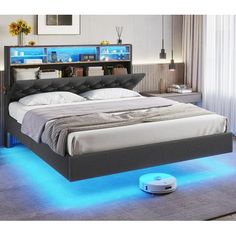 a bed with blue lights underneath it and a remote control on the floor next to it