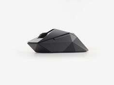 a computer mouse sitting on top of a white surface