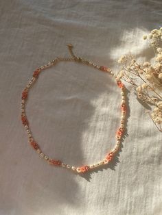 A handmade and beautiful pearl necklace made of flowers and freshwater pearls. This bracelet also goes great with it! https://www.etsy.com/de/listing/1423157681/handgemachte-perlenarmbander-aus DESCRIPTION: Discover our handmade pearl necklace "ROSÉ", which combines the delicate beauty of freshwater pearls with playful flowers. This unique necklace emphasizes your natural beauty and lets your inner radiance shine. Each bead tells a story of uniqueness and loving craftsmanship, while the delicate Handmade Delicate Flower Beaded Necklaces, Handmade Delicate Flower Beaded Necklace, Handmade Feminine Flower Necklace, Feminine Handmade Flower Necklace, Delicate Handmade Flower Beaded Necklace, Flower Charm Pearl Necklace, Dainty Pearl Necklaces With Colorful Beads, Handmade Feminine Pearl Jewelry, Gift Pearl Necklace With Flower Charm