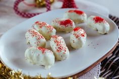 red and white sprinkles are arranged on a plate next to christmas decorations