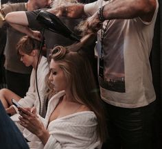 a woman is getting her hair cut at the salon