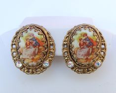 Beautiful West Germany signed clip on earrings Complete with a porcelain portrait of a courting couple Metal is brass with AB coated glass rhinestones   Time period: 1950s-1970s Dimensions: 1 x 0.8 inches In good wearable condition with NO missing stones or broken pieces Vintage items may have light scratches due to age and wear *Affordable combined shipping available* Thank you for looking and if you have any questions please don't hesitate to ask :) Vintage Enamel Wedding Earrings, Vintage Enamel Clip-on Earrings, Fan Necklace, Orange Candy, Broken Pieces, Enamel Flower, Lovely Necklace, West Germany, Clip On