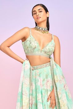 Mint attached can-can and satin lined lehenga with floral bloom print. Paired with a padded blouse with floral print base and all over threads, beads and sequin embroidery. Comes along with a dupatta.
Components: 3
Pattern: Print, Embroidery
Type Of Work: Floral, Stone, Beads
Neckline: V Neck
Sleeve Type: Sleeveless
Fabric: Tabby Silk, Lining: Satin
Color: Green
Other Details: 
Lehenga:
Attached can-can
Attached lining
Length: 44 inches
Stones and thread embroidered waistband
Blouse:
Padded
Dupa Summer Anarkali Lehenga With Floral Print, Bollywood Style Floral Print Choli For Summer, Summer Silk Lehenga With Dupatta, Summer Silk Lehenga For Reception, Silk Lehenga For Summer Reception, Anarkali Choli With Summer Floral Print, Summer Anarkali Choli With Floral Print, Silk Choli With Dupatta For Summer, Elegant Summer Lehenga With Floral Print