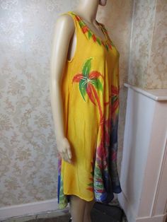 "Vintage tie dye summer dress in mainly yellow and blue. but has other bright colours.  It is sleeveless with a round neck and a very flared skirt.  This dress is lovely. Bust flat;  22\" Length;  39\" Made in India" Yellow Sleeveless Beach Cover-up Dress, Bohemian Sleeveless Beach Dress With Tropical Print, Colorful Sleeveless Dress For Beach Party, Multicolor Tropical Print Sundress For Summer, Colorful Floral Print Maxi Dress For Summer, Vibrant Print Summer Sundress, Yellow Flowy Dress For Beach Cover-up, Yellow Boho Dress With Floral Print For Vacation, Colorful Bohemian Maxi Dress For The Beach