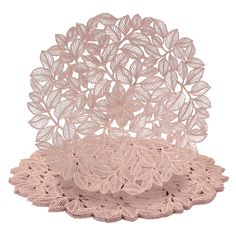 two pink doily plates with leaves on the top and one is made out of lace