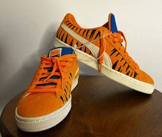 This PUMA Suede x Frosted Flakes Low sneaker is a must-have for any sneaker collector or fan of Tony the Tiger. The shoe features a bright orange color and low-top shaft style, making it perfect for a variety of activities such as cycling, basketball, and skateboarding. It is available in size 6.5 for both men and women. The sneaker is made of suede material and has a PUMA X product line. It also comes with a style code of 388018-01 and was released in 2022. This athletic shoe is suitable for various performance and activities such as golfing, hiking, and walking. Don't miss out on adding this unique and stylish sneaker to your collection! Orange Low-top Sneakers With Gum Sole, Orange Sneakers With Gum Sole For Streetwear, Casual Orange Sneakers With Gum Sole, Orange Custom Sneakers With Gum Sole For Sports, Custom Orange Sneakers With Gum Sole For Sports, Orange Custom Sneakers With Rubber Sole For Streetwear, Orange Custom Sneakers For Streetwear With Rubber Sole, Orange Custom Sneakers With Gum Sole, Casual Orange Sneakers For Streetwear