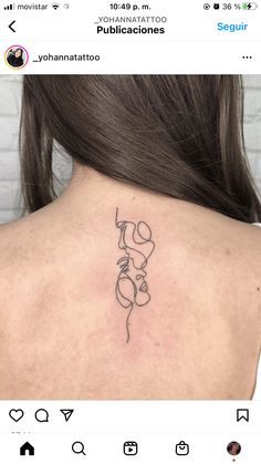 the back of a woman's neck with a tattoo on it