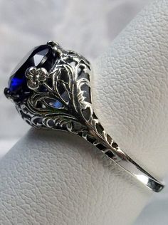 blue sapphire solitaire ring with swirl antique floral sterling silver filigree Victorian Sapphire Ring, Classic Filigree Ring With Intricate Design, Victorian Filigree Ring With Diamond Cut, Ornate Round Filigree Ring With Prong Setting, Victorian Diamond Cut Filigree Ring, Vintage Silver Solitaire Sapphire Ring, Vintage Silver Sapphire Solitaire Ring, Exquisite Silver Filigree Ring With Round Cut, Formal Sapphire Filigree Round Ring