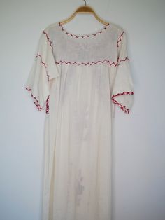 "Beautiful Antique 0ff-White Cotton Gauze Maxi Dress with Floral Hand Embroidery . Features hand embroidered flowers on chest front, neck and sleeves. Half Sleeve drawstring at cuff sleeves. Condition: Good Vintage Condition. ** black spot on hip area and missing embroidered detail on skirt. \"shown in the detailing picture \" BEST FIT = M Please be sure to check the measurements to insure a perfect fit. Details and Measurements (Inch) BUST: 38 \" HIPS: 50 \" FULL LENGTH: 52 \" SLEEVE LENGTH: 11 Folk Cotton Dress With Resham Embroidery, Folk Style Festive Dress With Chikankari Embroidery, Festive White Tunic Dress, Traditional Long White Dress, White Resham Embroidery Dress For Festival, Traditional Off White Dress With Resham Embroidery, Traditional Cream Dress With Floral Embroidery, Traditional Off White Dress With Floral Embroidery, Festive White Dress With Intricate Embroidery