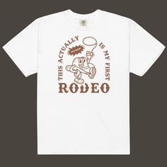 "Yee-haw, cowboy or cowgirl! Giddy up in style with our \"This Actually Is My First Rodeo\" Retro Character Comfort Colors T-shirt! This tee is as thick as a Texas steak and as soft as a gentle cowboy's touch. Made of 100% ring-spun cotton, it's perfect for ropin', ridin', and relaxin' in comfort. The regular t-shirt style fits you like a well-worn saddle, making you the rootin'-est, tootin'-est fashionista in town. Because who doesn't love a comfort colors shirt? It's like riding a trusty steed White Western T-shirt For Rodeo, Retro Screen Print Tops For Rodeo, Retro Letter Print Tops For Rodeo, White Graphic Tee For Western-themed Events, Retro Western Style Short Sleeve Top, White Crew Neck T-shirt For Rodeo, White Screen Print T-shirt For Rodeo, Retro Rodeo T-shirt With Screen Print, White Letter Print T-shirt For Ranch