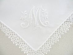 an embroidered monogram on a white handkerchief