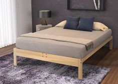 a bed sitting on top of a wooden frame