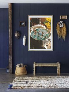 a living room with blue walls and pictures on the wall, including an old bench