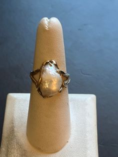 This is a vintage size 7 1/2 baroque pearl ring. It has a stunning white high luster baroque pearl set in solid 14k gold. The large pearl measures about 11.5mm by 15.5mm. The total weight of the ring is 6.6 grams. The pearl is set in solid 14k gold with natural branch like prongs. This classic art nouveau style ring will make a statement at any event. This ring can easily be resized by a jeweler. Heirloom High Luster Oval Pearl Ring, Victorian Pearl Jewelry For Anniversary, Gold Victorian Pearl Ring With Gemstone, Victorian Gold Pearl Ring With Gemstone, Victorian White Gold Pearl Ring For Formal Occasions, High Luster 14k Gold Pearl Ring As Gift, Victorian Style White Gold Pearl Ring For Formal Occasions, Heirloom High Luster Ring Jewelry, Heirloom White Jewelry With High Luster