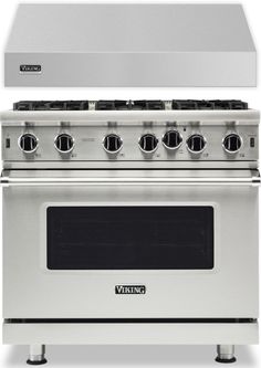 a stainless steel stove with four burners and two oven hoods on each side