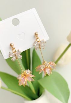 These unique handmade earrings feature a beautiful lotus flower design. Crafted from high quality materials, they make a perfect gift for the special someone in your life. Show your loved one how much you care with these stunning lotus earrings. Detail: - Size of earring: 50mm Material: flowers - resin; ear wires - 18k gold plated The Handmade Flower Earrings are sold in pairs of two earrings. Gold Petal Flower Earrings For Gifts, Feminine Flower Decorated Earrings For Gift, Delicate Dangle Flower Earrings For Bridesmaids, Rose Gold Flower Earrings As Gift, Rose Gold Flower Earrings For Gift, Gold Dangle Flower Earrings For Bridesmaids, Delicate Drop Flower Earrings For Bridesmaid Gift, Feminine Bridal Drop Earrings As Gift, Feminine Bridal Drop Earrings For Gifts