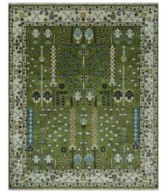 a green rug with blue and white flowers on the bottom, in an ornate pattern