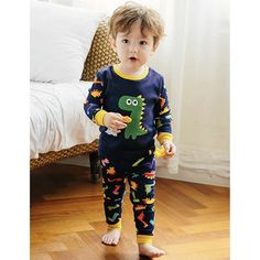 DESCRIPTION These fun, comfortable cotton pajamas make the perfect addition to any jammie collection. These jammies are 100% cotton, soft and comfortable for your little dinosaur lover. Pants are pull-on with wide elastic waist band, and the top and pants are ribbed at the waist and cuffs. Both also have a tagless label for your child's comfort. The fit is super snug so you may need to go up a size or if your child is on the cusp of going up a size soon, you may want to go up two sizes. DETAILS Fun Cotton Loungewear Set, Family Matching Cartoon Print Sleepwear, Fun Cotton Sleepwear Set, Fun Cotton Sleep Sets, Playful Cartoon Print Sleepwear, Fun Cartoon Print Sleepwear For Bedtime, Fun Cartoon Print Sleepwear, Fun Cartoon Print Sleepwear For Loungewear, Cute Dinosaur Print Playwear Sets