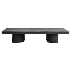 a black table sitting on top of a white wall