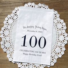 a white doily with the words celebrating 100 years on it