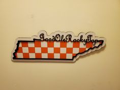 an orange and white checkered state shaped magnet