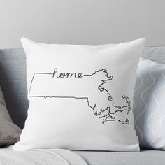 a black and white throw pillow with the word home on it