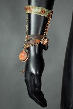 A simple and stylish bracelet, consisting of two pieces connected with chains: a leather string and an upcycled army strap. This jewelry piece is made by hand, from recycled materials. It has a nice rusty finish and dangling charms with a bottlecap and a leather tassel. It's a great eye-catching detail that will add a bling to your festival costume! All of our clothes are handmade, which is why individual pieces may slightly differ from those shown in the photos. If you can't find your size or would like to customize this product according to your preferences, please don't hesitate to contact us. MORE APOCALYPTIC CLOTHES AND ACCESSORIES AT: https://www.etsy.com/shop/WastedCouture ------------------------------ Wasted Couture - WastedCouture Wear if you dare! Punk Style Festival Bracelet, Punk Style Metal Bracelet Strap Jewelry, Punk Metal Jewelry With Bracelet Strap, Punk Style Metal Bracelet, Adjustable Metal Gothic Wristband, Festival Metal Chain Bracelet With Adjustable Chain, Adjustable Metal Chain Bracelet For Festivals, Adjustable Brass Chain Bracelets, Adjustable Brass Chain Bracelet