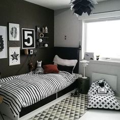 a bed room with a neatly made bed and various pictures on the wall above it