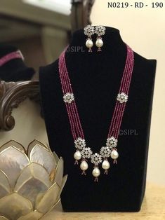 Pretty floral designer long mala/ designer necklace / ad jewelery/ kundan jewelery/ long necklace / punjabi jewellery / pakistani jewelry Beautiful long necklace made in real onex beads with pretty floral design in faux american diamond paired with cute earrings. Beads used in necklace is real onex crystal beads glass made NO PLASTIC Easy to wear, Light in weight & gives you a classy Look. It can be wear in festival occasion with matching salwar suit, saree or any traditional  Polki,AD Diamond N Long Moti Necklace, Luxury Temple Jewelry Necklace With Dangling Beads, Punjabi Jewellery, Beautiful Beaded Necklaces, Black Beads Mangalsutra Design, Fancy Jewelry Necklace, Unique Pendant Necklace, Pearl Necklace Designs, Diamond Necklace Designs